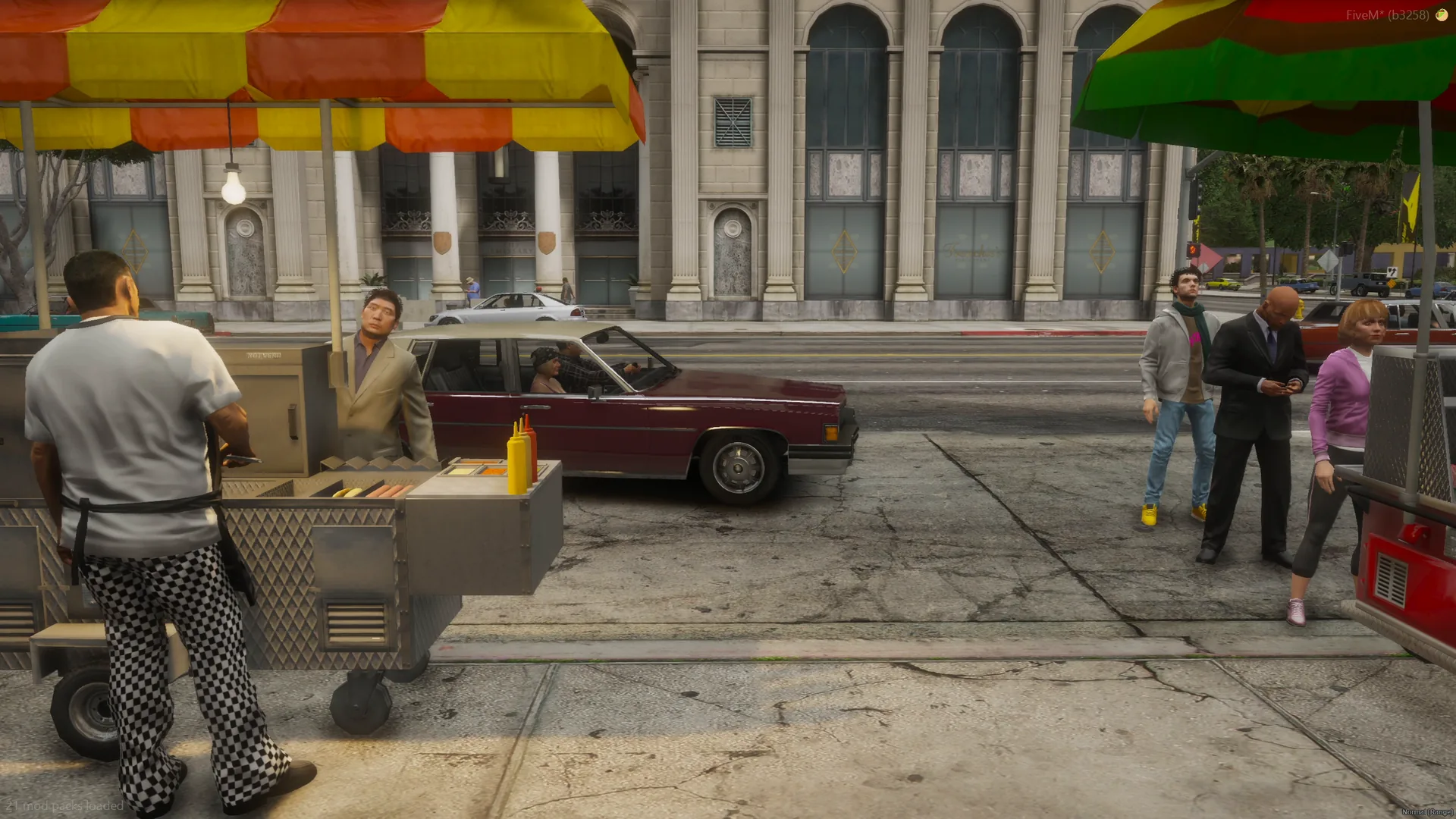 Hot dog vendor working his cart on a city sidewalk while customers wait next to the burger stand